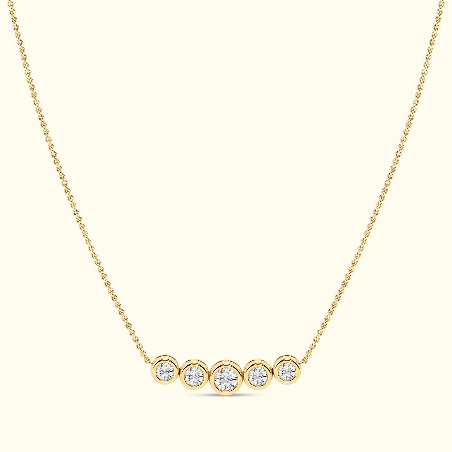 Gold necklace with five round diamonds set in circular settings.