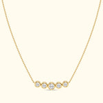 Gold necklace with five round diamonds set in circular settings.