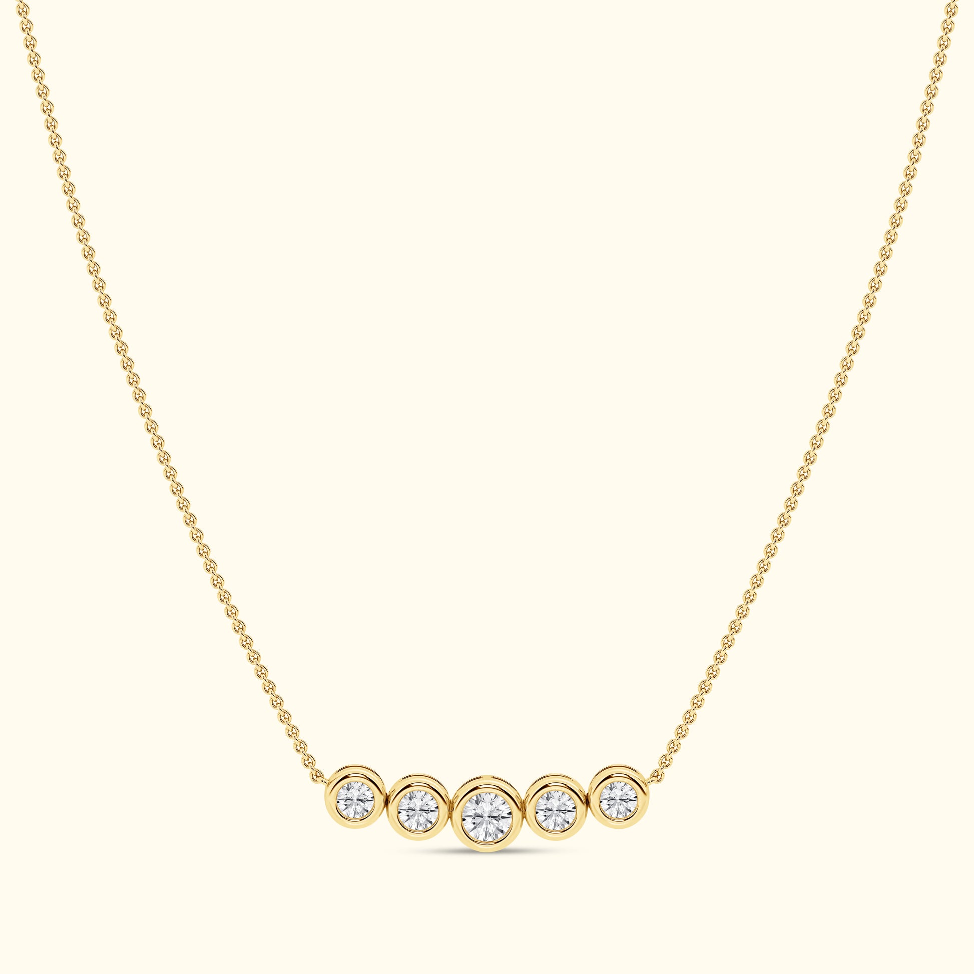 Gold necklace with five round diamonds set in circular settings.