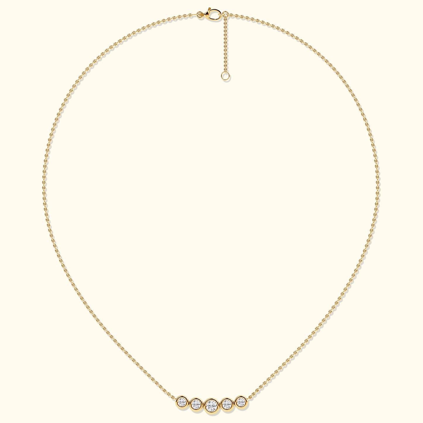 Delicate gold necklace featuring five sparkling diamond-like stones.