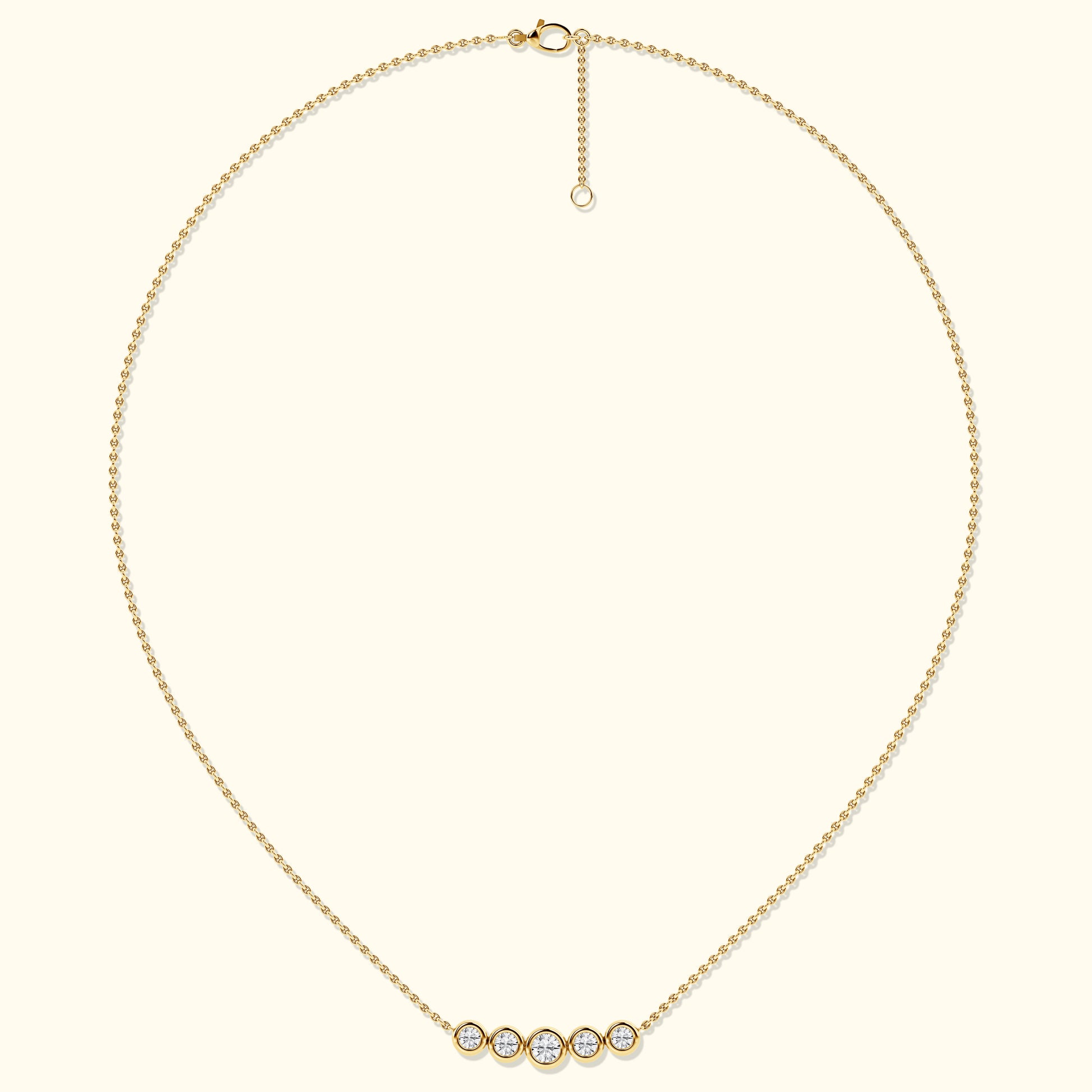 Delicate gold necklace featuring five sparkling diamond-like stones.