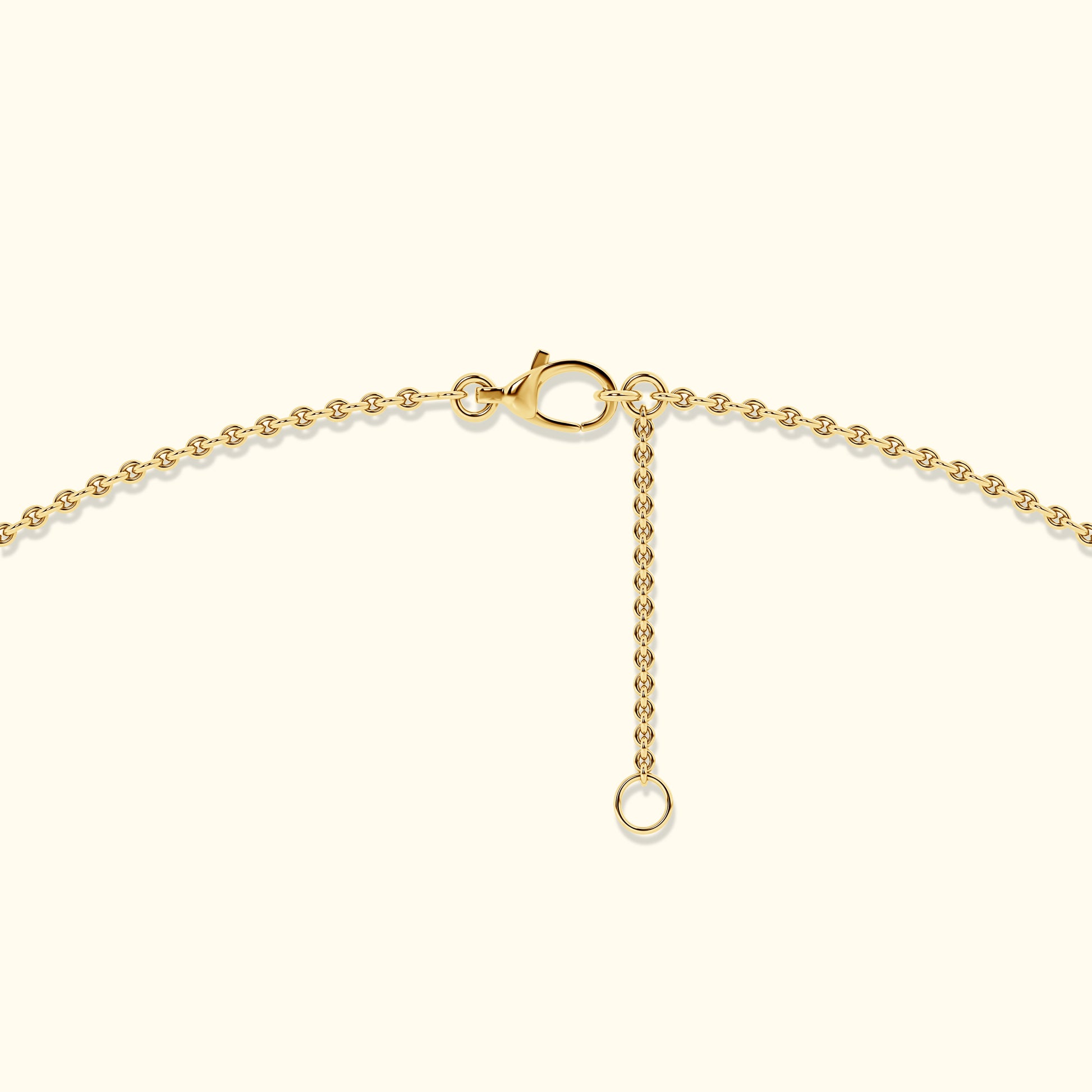 Close-up of a gold necklace clasp with an adjustable chain.