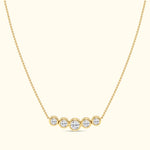 Gold necklace featuring five round diamonds arranged in a horizontal line.