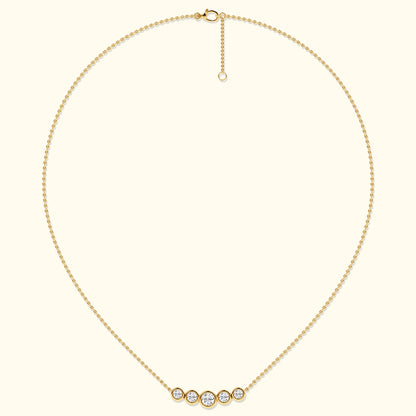 Delicate gold necklace with five sparkling diamonds in circular settings.