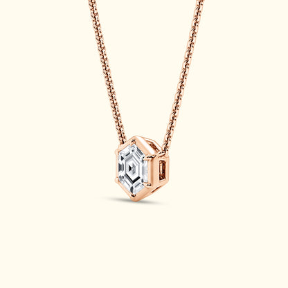 Rose gold necklace featuring a hexagonal, clear gemstone pendant.