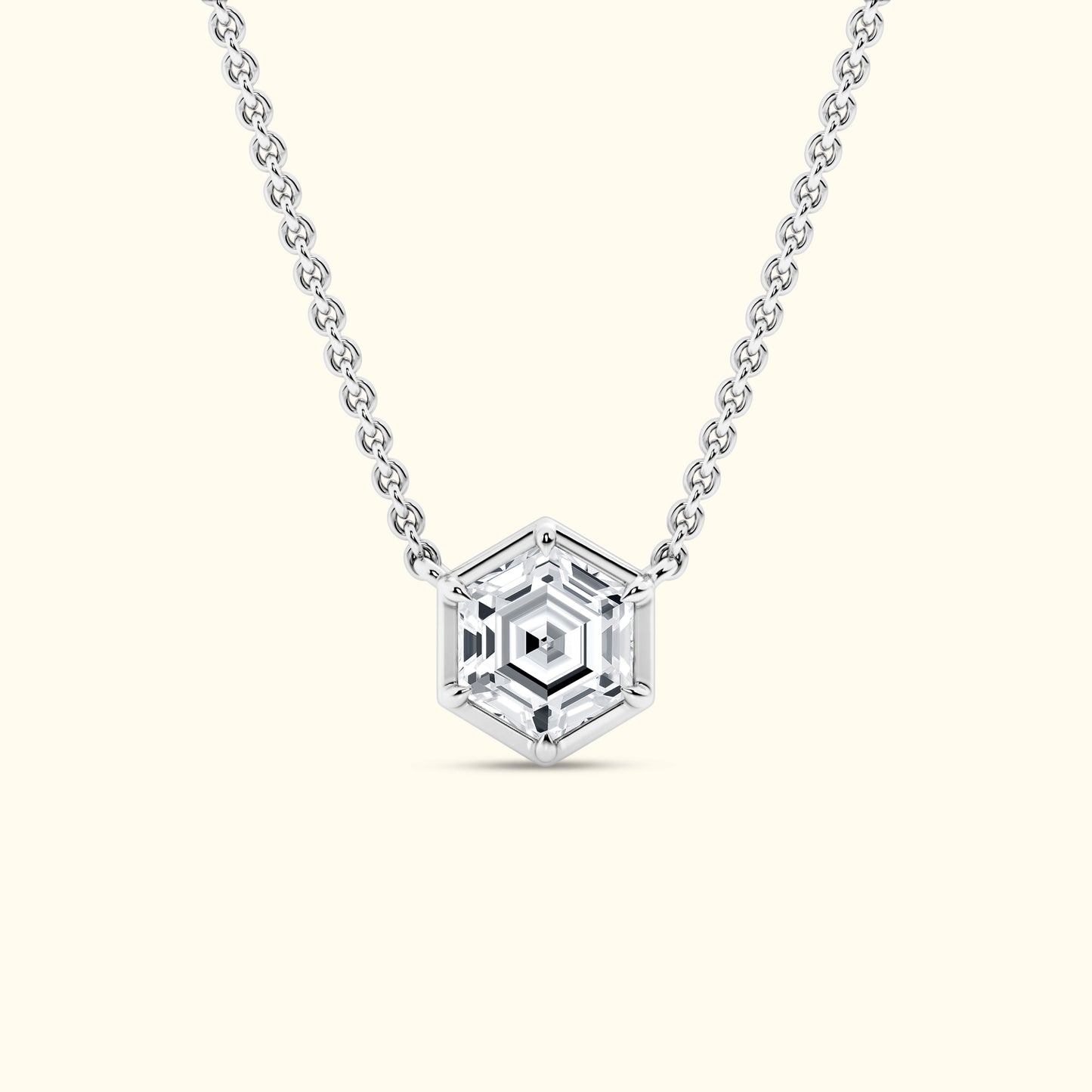 Silver necklace with a hexagonal pendant featuring a faceted gemstone.