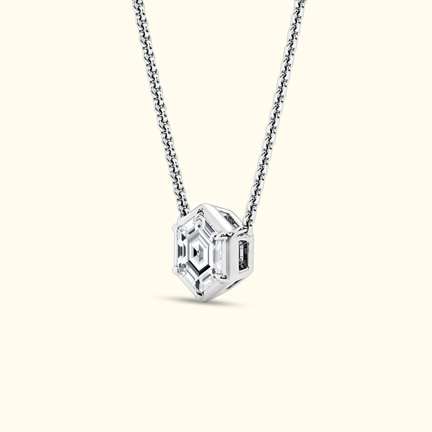 Geometric pendant necklace with a hexagonal faceted crystal on a silver chain.