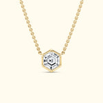 Gold chain necklace featuring a hexagonal clear gemstone pendant.