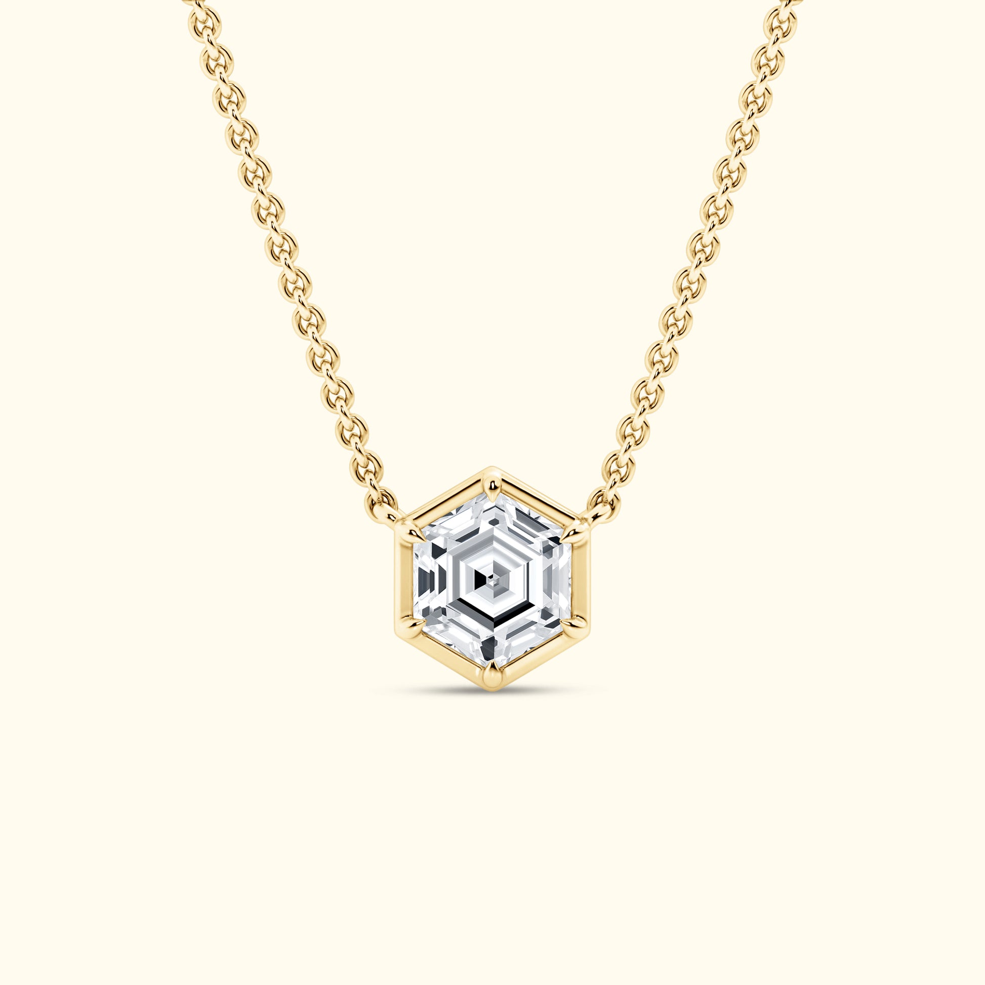 Gold chain necklace featuring a hexagonal clear gemstone pendant.