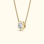 Gold necklace featuring a hexagonal pendant with a clear diamond center.