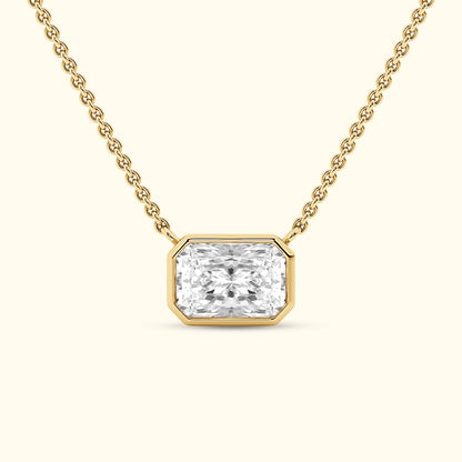 Elegant gold necklace featuring a rectangular diamond pendant.