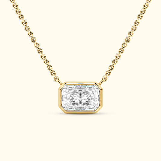 Elegant gold necklace featuring a rectangular diamond pendant.