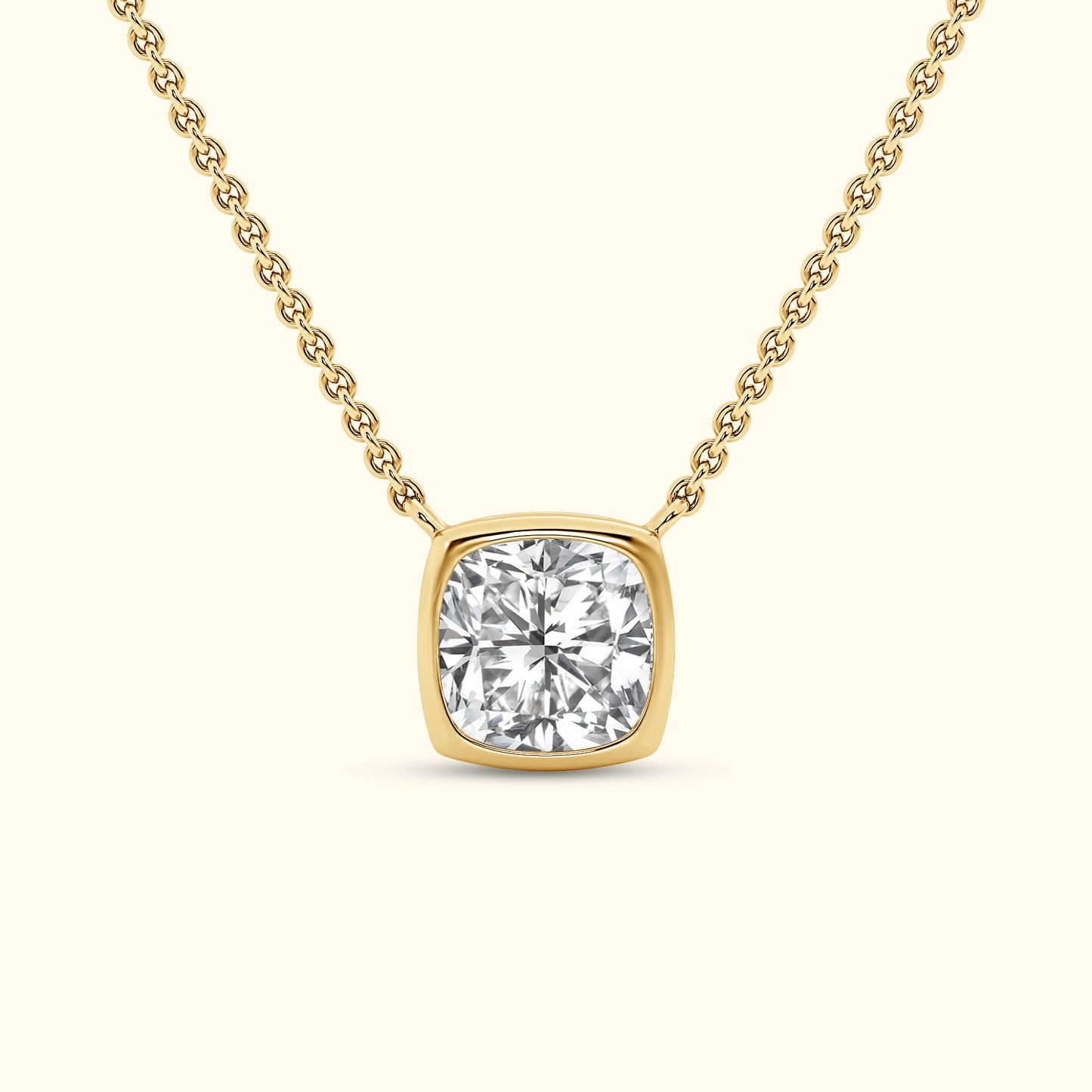 A gold necklace featuring a square-cut diamond pendant on a delicate chain.