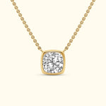 A gold necklace featuring a square-cut diamond pendant on a delicate chain.