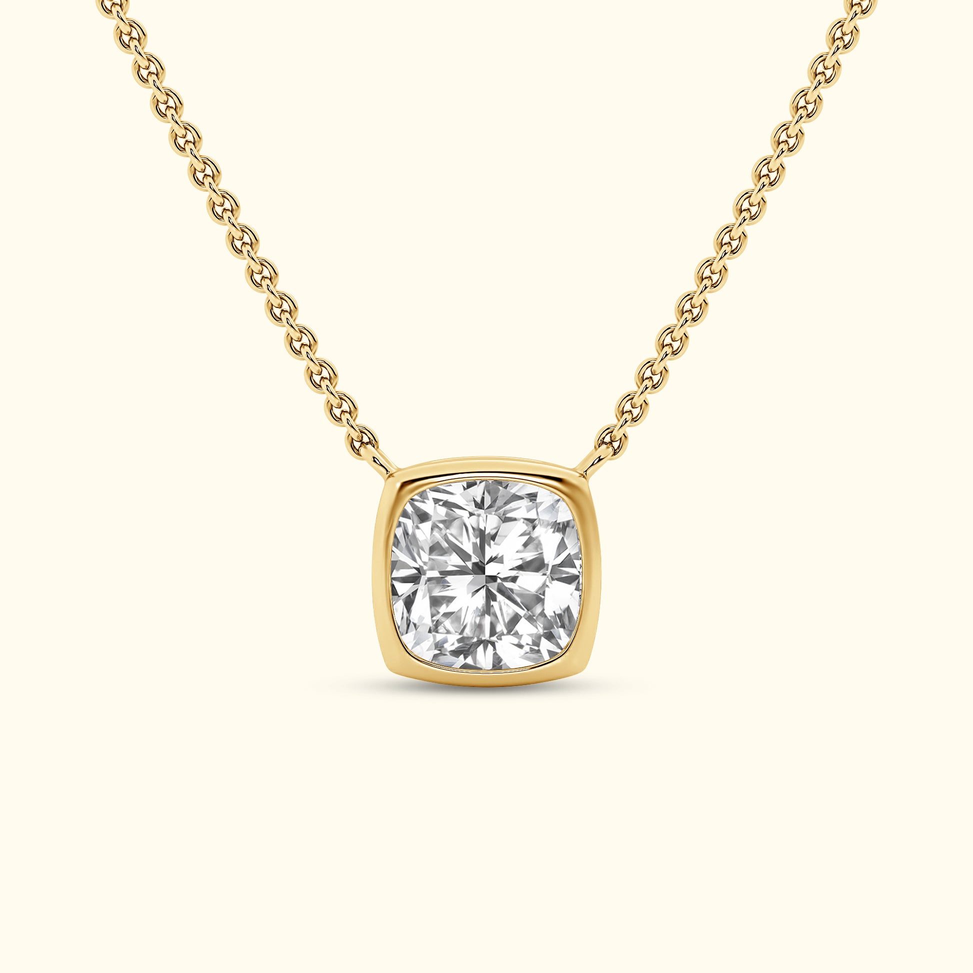 A gold necklace featuring a square-cut diamond pendant on a delicate chain.