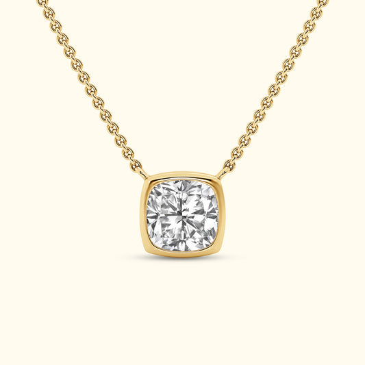 A gold necklace featuring a square-cut diamond pendant on a delicate chain.