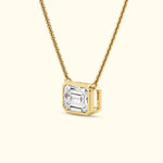 Gold necklace featuring a rectangular diamond pendant on a delicate chain.