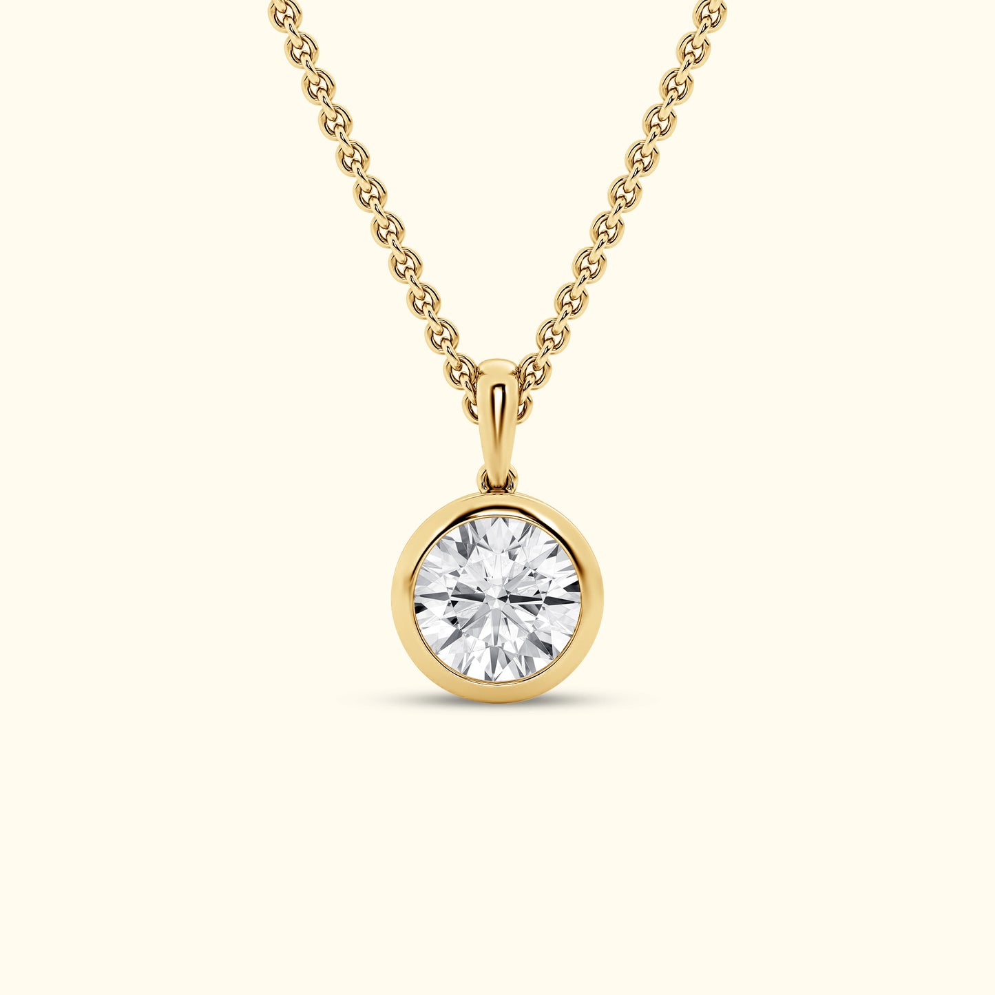 Gold pendant necklace featuring a round, brilliant-cut diamond.