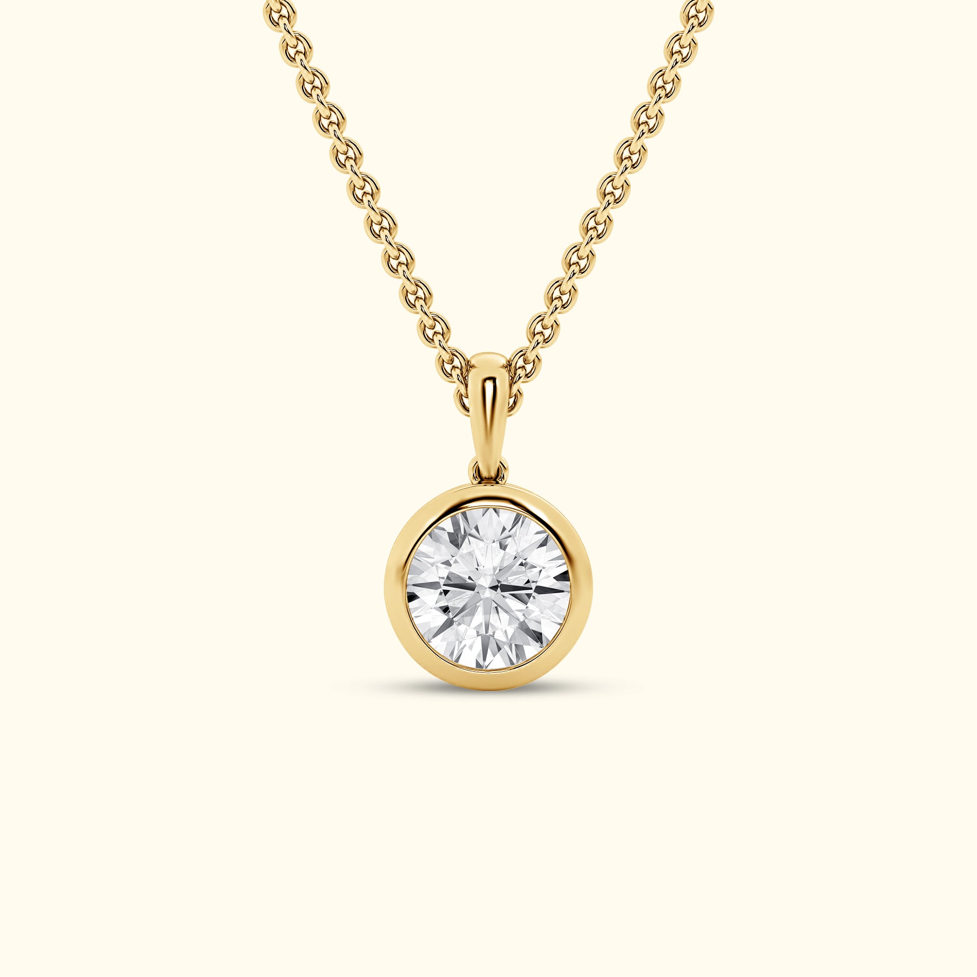 Gold pendant necklace featuring a round, brilliant-cut diamond.