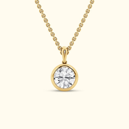 Gold pendant necklace featuring a round, brilliant-cut diamond.