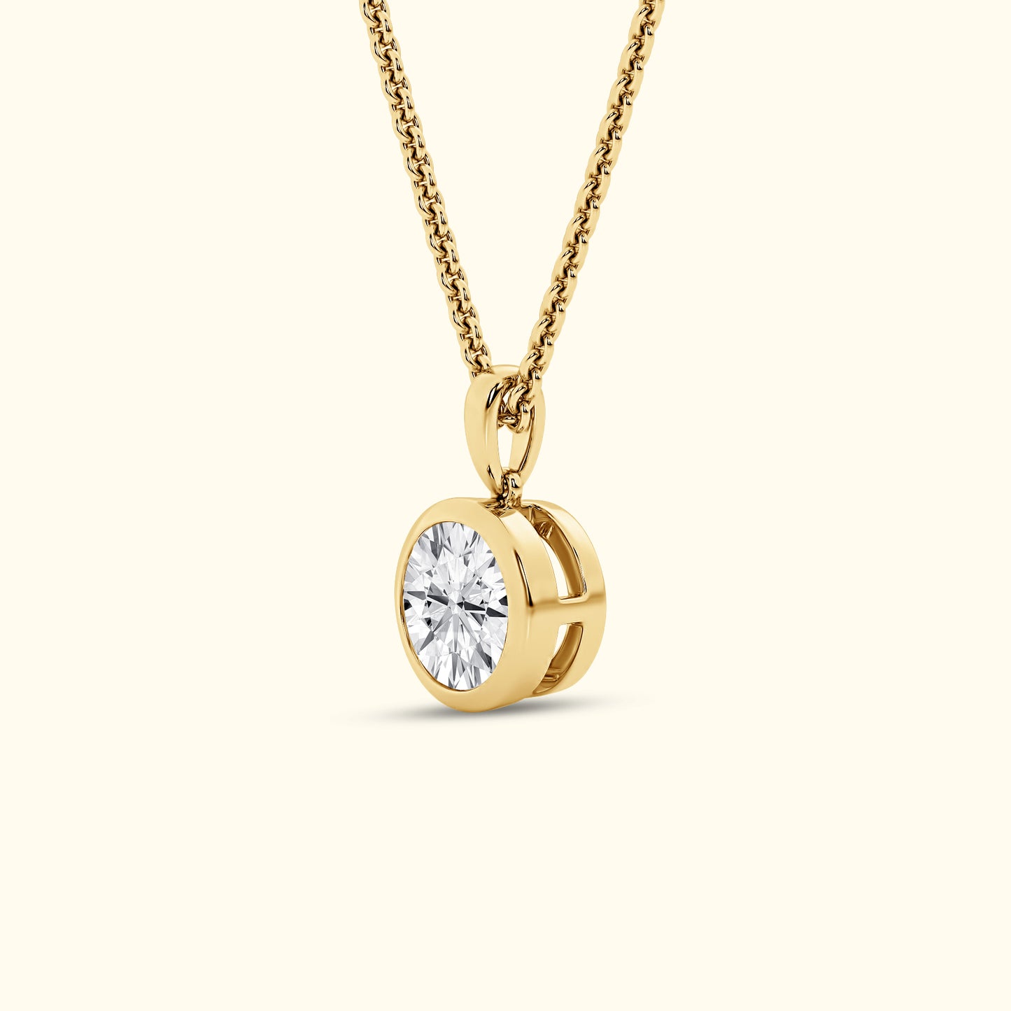 Gold necklace featuring a single round diamond pendant.