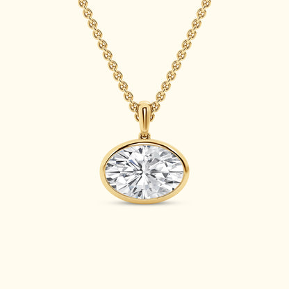 Gold necklace with an oval diamond pendant.