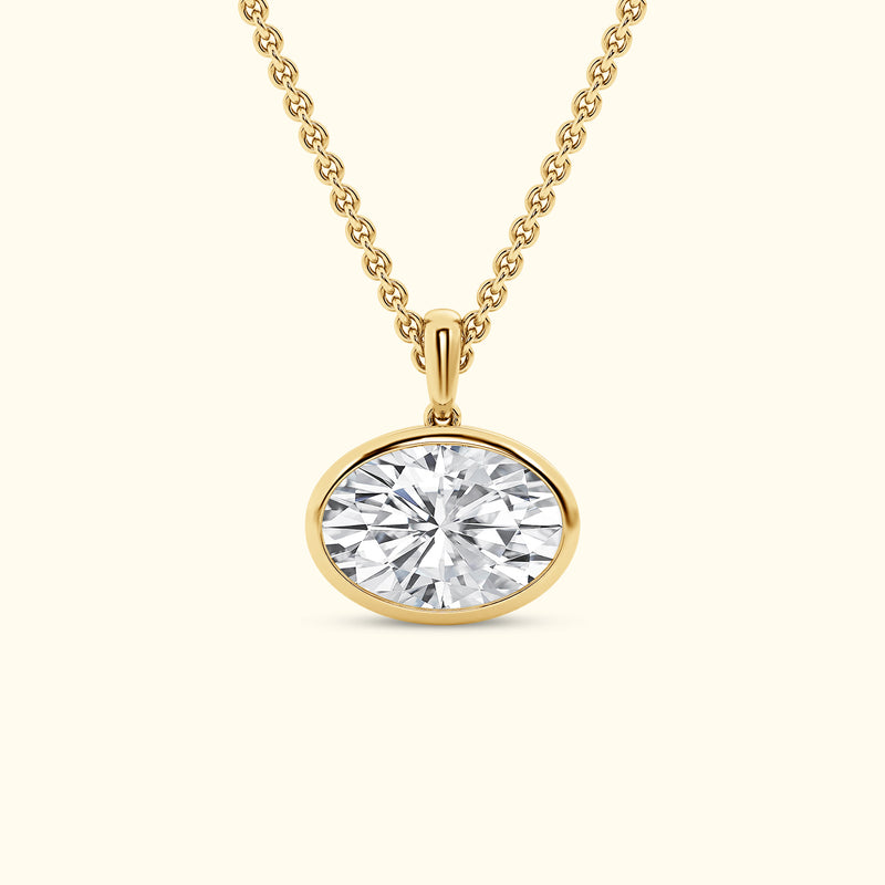 Gold necklace with an oval diamond pendant.