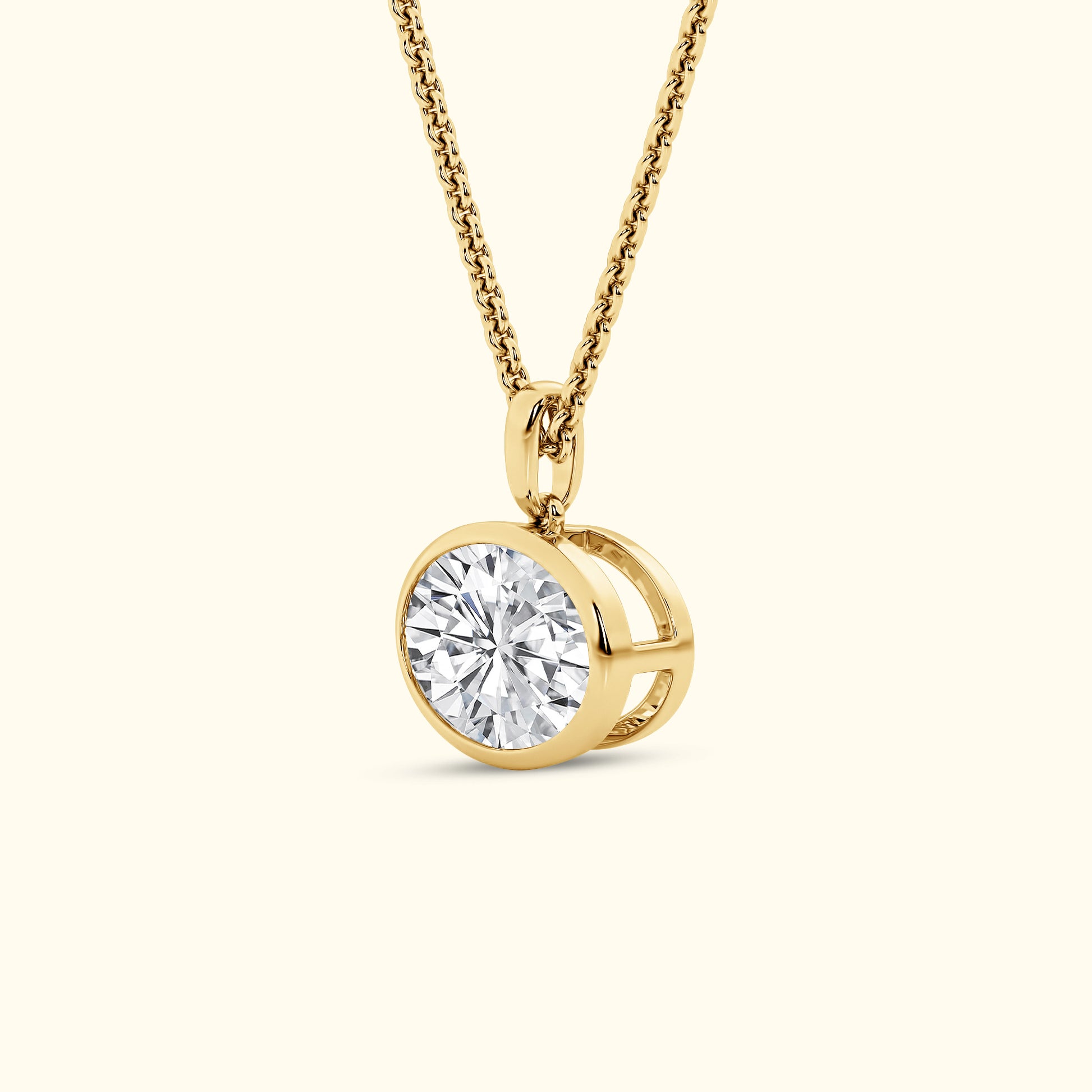 Gold pendant necklace featuring a round, sparkling diamond.