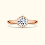 Rose gold ring featuring a hexagonal diamond centerpiece in a delicate setting.