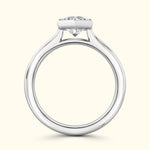 Sleek silver engagement ring featuring a prominent round diamond on a simple band.
