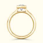 Elegant yellow gold engagement ring featuring a prominent diamond on a sleek band.