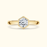 Gold ring featuring a hexagonal diamond setting with a polished band.