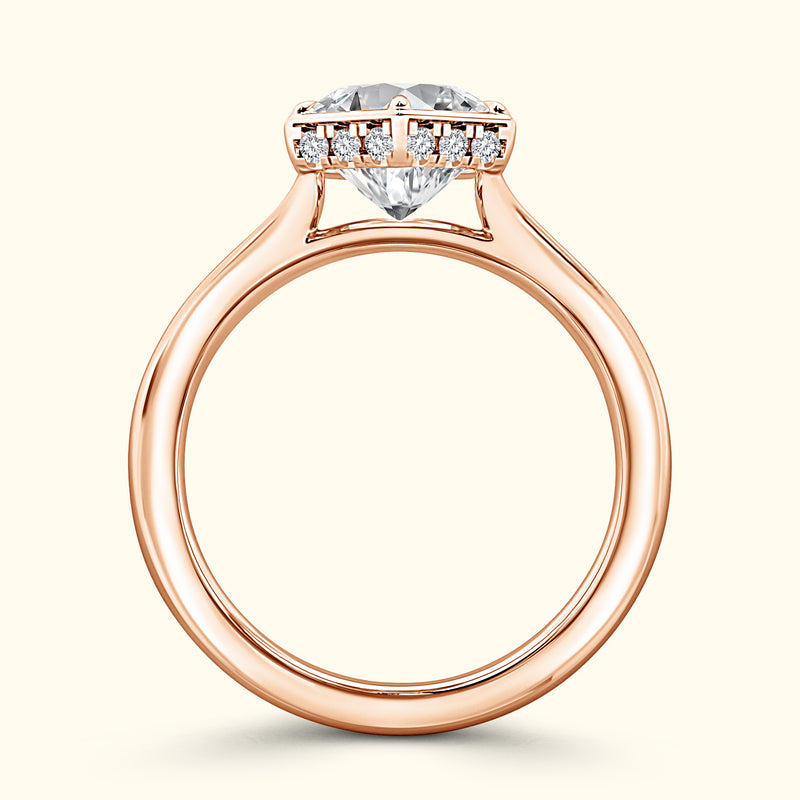 Rose gold ring with a large heart-shaped diamond and small accent diamonds.