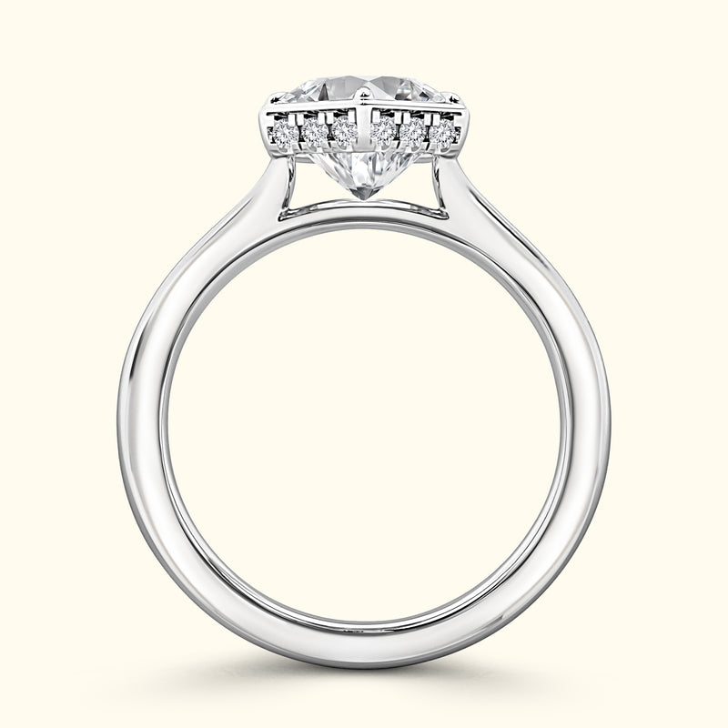 Heart-shaped diamond engagement ring with a sleek silver band and accent stones.
