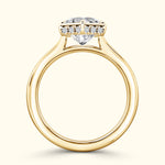 Heart-shaped diamond engagement ring with a yellow gold band and accent stones.