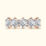 Rose gold ring featuring five hexagonal clear gemstones in a patterned design.