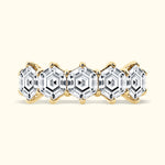 Gold band ring featuring five hexagonal clear gemstones.