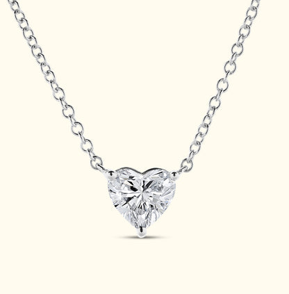 Heart-shaped diamond pendant on a delicate silver chain.